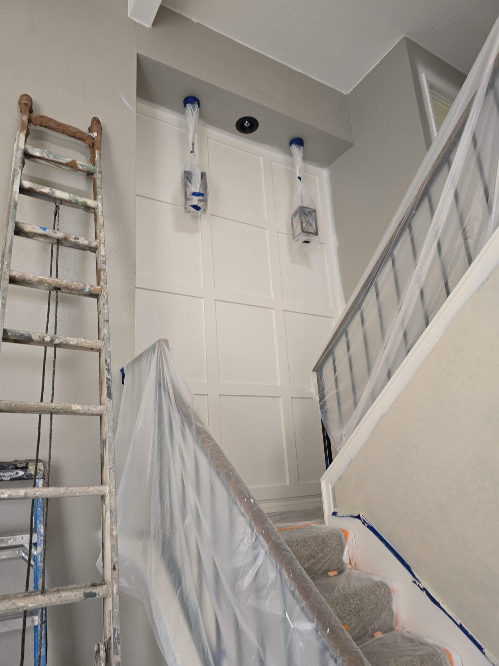 Freshly painted wall with decorative paneling in a home interior, showcasing professional residential painting services. The image highlights step-by-step wall preparation and painting process.